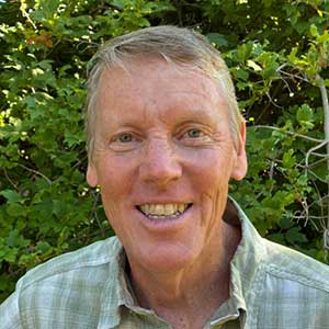 Headshot of Randall Krag by a tree